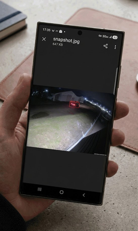 Phone displaying an attached camera snapshot showing a detection event at a self-storage facility
